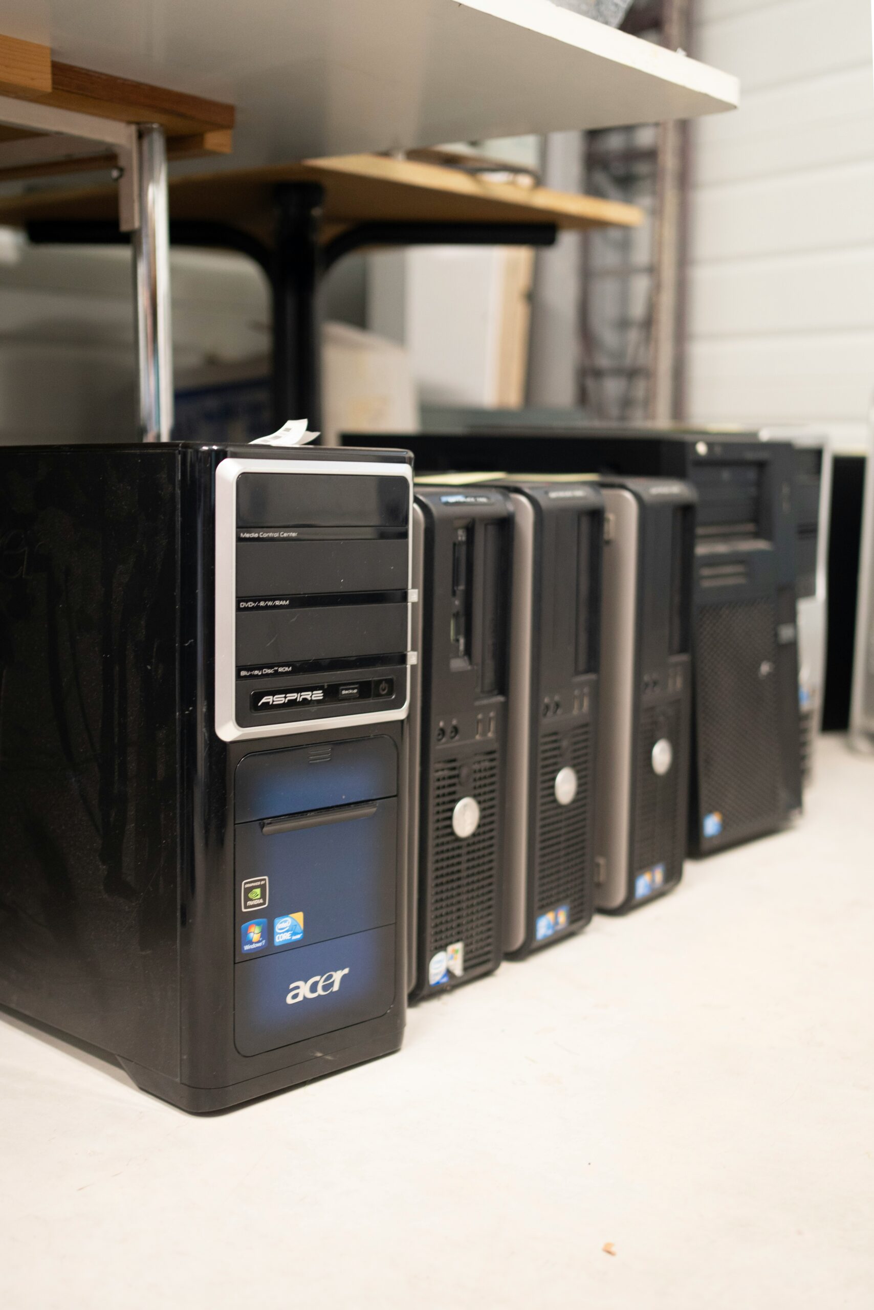 a row of black computers sitting on top of a table